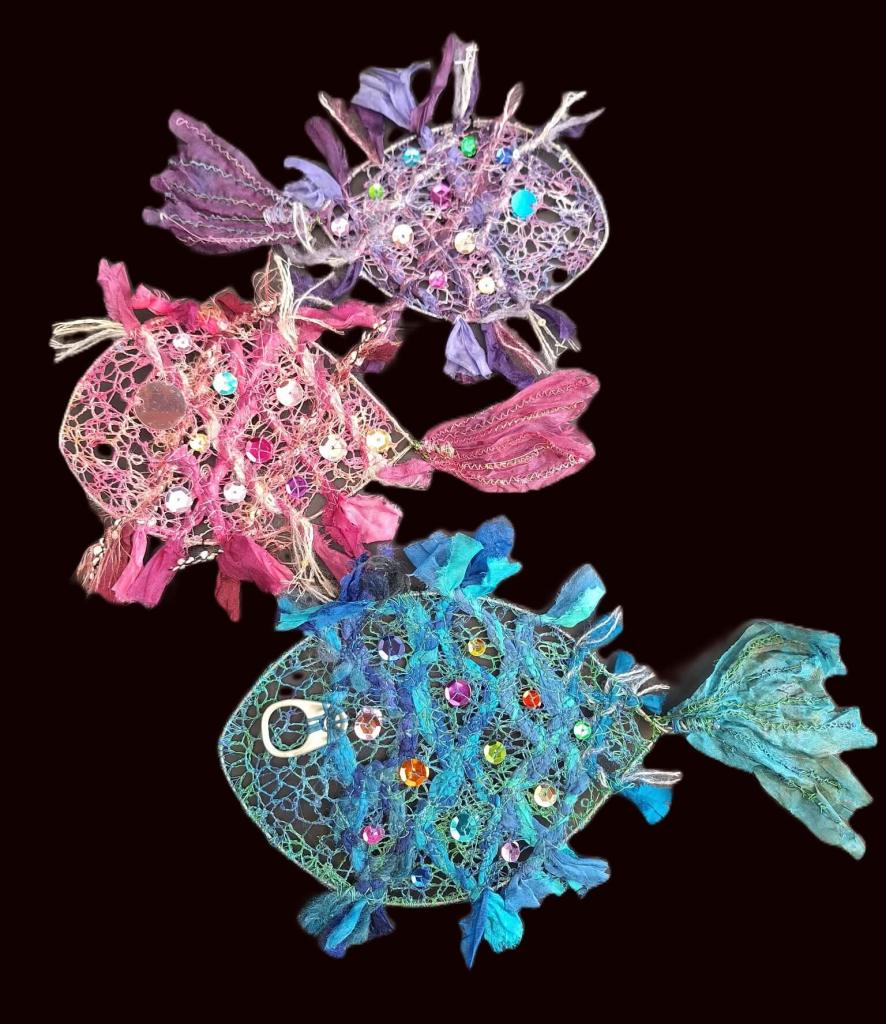 Wire framed fish in purple, pink and blue made from machine embroidered, silk strips, sequins with ring pull eyes